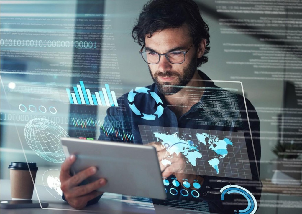 man with a tablet in fromt of semi-transparent screens