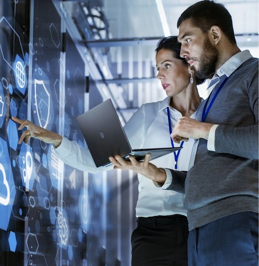 Woman and man with a laptop discussing business tech in tech environment