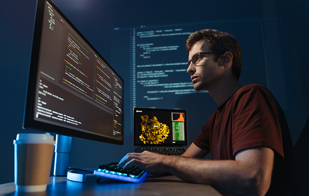 software engineer in front of display with code lines