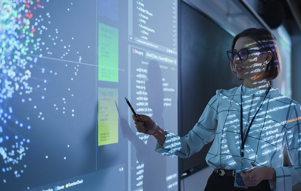 Woman pointing to dashboards on a stand